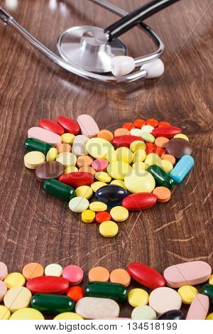 Heart Shaped Colorful Medical Pills And Capsules With Stethoscope, Health Care Concept
