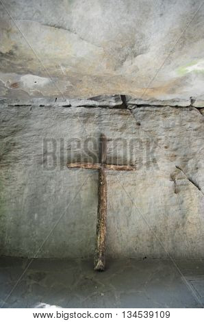 Ancient wooden cross placed in a cave