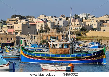 MARSAXLOKK MALTA - APR 18 :The iconic Malta fishing boats in the Marsaxlokk village in Malta April 18 2011. They are usually painted in bright colours while the bow has a pair of eyes