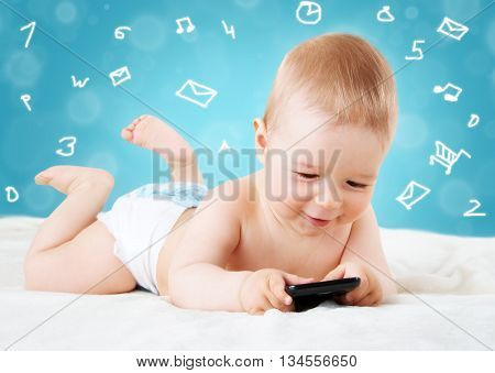 Baby holding a mobile phone on blue background