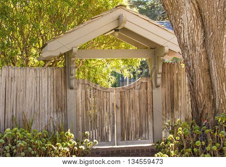 Wooden entrance gate to garden .nice landscaping