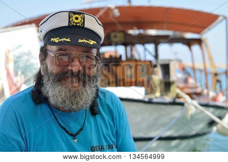 CHANIA GREECE - AUGUST 12: Unknown man captain of cruise boat in Chania harbor Greece on August 12 2014. Chania is one of the most popular tourist place on Crete island in Greece.
