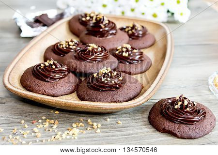 Chocolate cookies with ganache cream and hazelnut