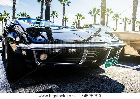 Benalmadena, Spain - June 21, 2015: A black Chevrolet Corvette C3, front view, parked in the port of Benalmadena (Spain), on June 21, 2015.