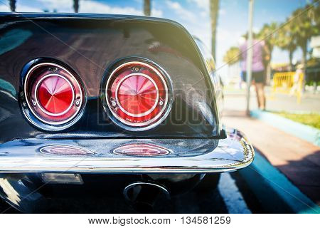 Benalmadena, Spain - June 21, 2015: Rear lights of black Chevrolet Corvette C3, parked in the port of Benalmadena (Spain), on June 21, 2015.