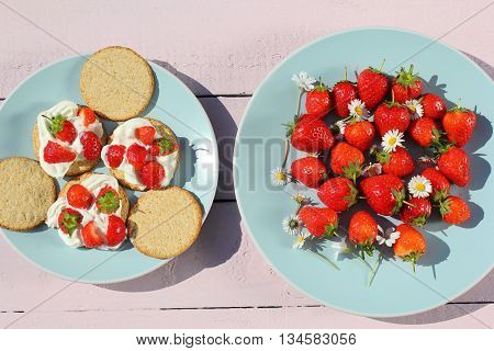 Oat buiscits with cream and fresh strawberries close up