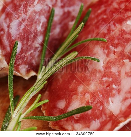 tasty green Rosemary and italian salami closeap