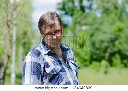 Man is looking over his glasses with skepticism and disbelief