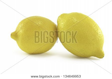Two ripe lemons isolated on white background.