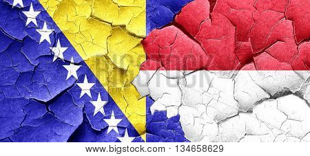 Bosnia and Herzegovina flag with Indonesia flag on a grunge crac