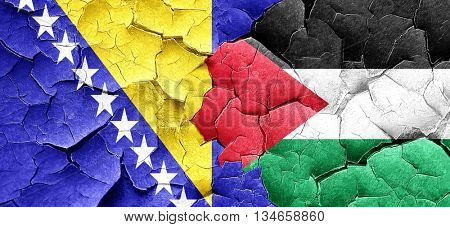 Bosnia and Herzegovina flag with Palestine flag on a grunge crac