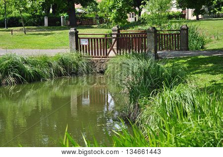 Footbridge leads over the lake at public park