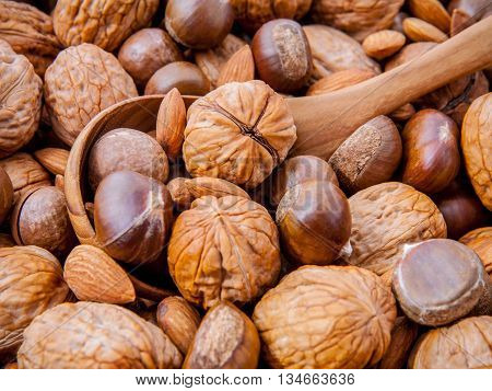 Background With Different Kinds Of Nuts  Walnuts Kernels ,macadamia,hazelnut, And Almond With Wooden