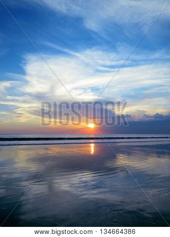 Beautiful sunset sky with reflection at Kuta and Seminyak beach, Bali