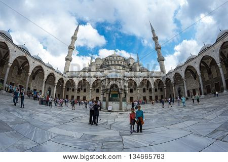 ISTANBUL TURKEY - JUNE 19 2015: People visiting Sultan Ahmet Mosque (Turkish: Sultan Ahmet Camii) a historic mosque in Istanbul Turkey. The mosque is popularly known as the Blue Mosque for the blue tiles adorning the walls of its interior