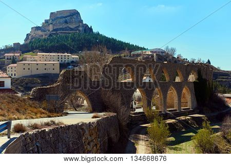 View to the aqueduct and the Morella castle. Morella is in the heart of the historic region of Meastrazgo and it is listed as one of the most beautiful towns in Spain