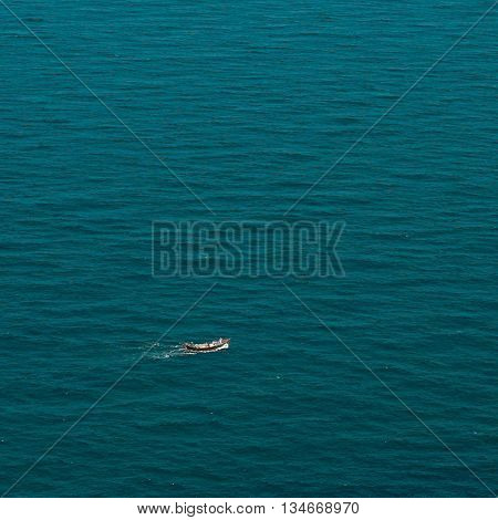 Fishermen on the ocean catching fish alone