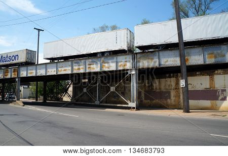 JOLIET, ILLINOIS / UNITED STATES - MAY 3, 2015: A freight train crosses a bridge over Scott Street near downtown Joliet, Illinois.