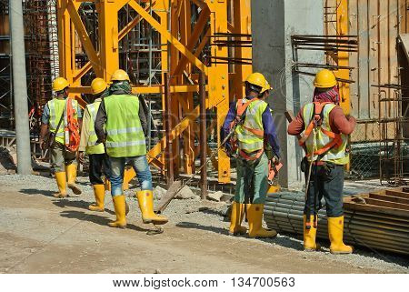 MALACCA, MALAYSIA -MARCH 13, 2016: Construction workers at the construction site in Malaysia. All of them is required to wear adequate safety equipment during works to make sure their safety.