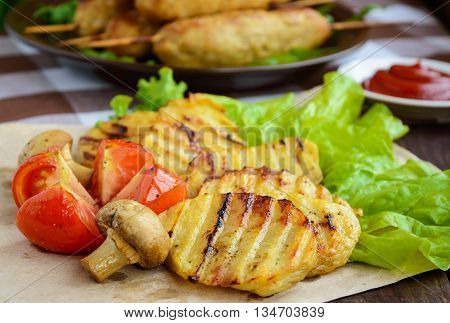 Grilled vegetables: tomatoes potatoes mushrooms and herbs. Close-up