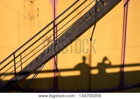 People Shadows On Old Metal Tanks In Power Plant,