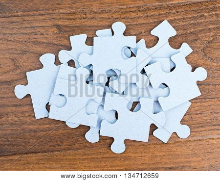 Pile of puzzle pieces on table, top view