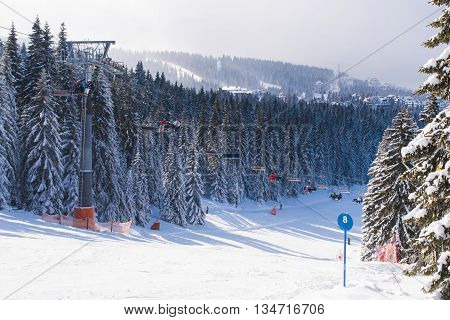 Kopaonik, Serbia - January 22, 2016: Ski resort Kopaonik, Serbia, people on the ski lift ,mountains, houses and buildings panorama