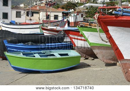 Fishing boats drawn up on beach and slipway at Camara de Lobos in Madeira Portugal