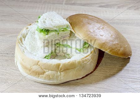 Sandwich Box With Chicken Burger, Tomatoes, Ham, Tuna, Cheese On Wood Table.