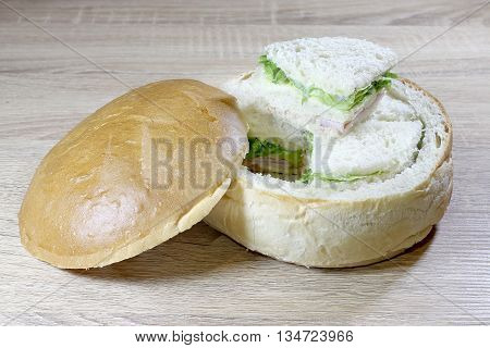 Sandwich Box With Chicken Burger, Tomatoes, Ham, Tuna, Cheese On Wood Table.