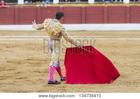 Andujar Spain - September 11 2010: The Spanish Bullfighter David Valiente bullfighting with the crutch in the Bullring of Andujar Spain