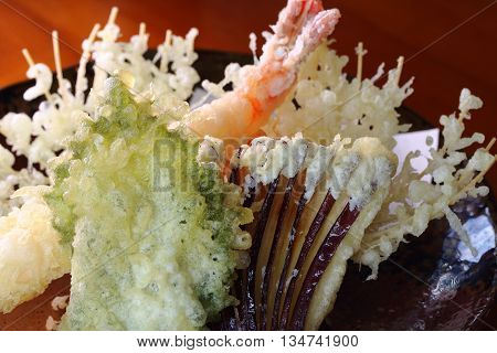 Japanese tempura set consisting of egg plant shrimp carrot pepper and shiso leaf