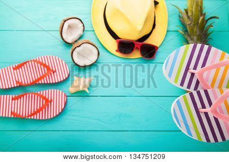 Beach accessories on blue wooden floor. Top view