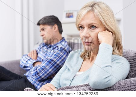 Mature Couple With Relationship Difficulties Sitting On Sofa
