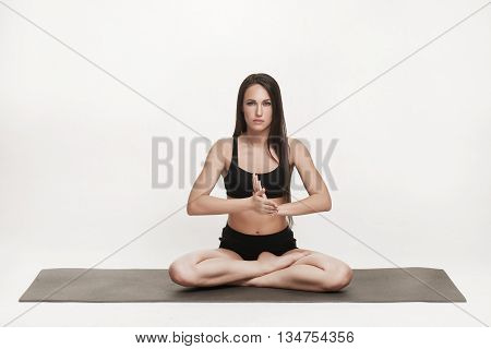 Portrait of young attractive woman doing yoga. Brunette with fit body on yoga mat. Healthy lifestyle and sports concept. Series of exercise poses.