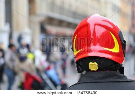 Watch fireman with red Hardhat in the city with people