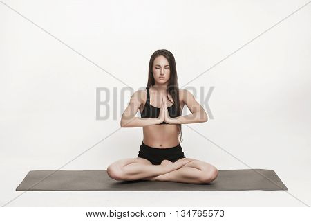 Portrait of young attractive woman doing yoga. Brunette with fit body on yoga mat. Healthy lifestyle and sports concept. Series of exercise poses.