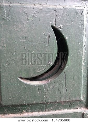 Quarter moon outhouse window on a door