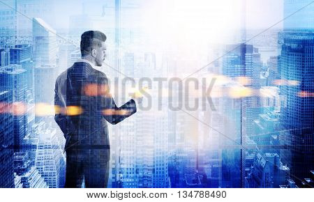 Stylish young businessman using smart phone on New York city background. Double exposure