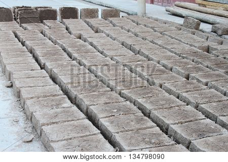 Rows of adobe bricks drying in the sun in Peru