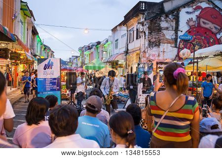 PHUKET THAILAND MAY 29 2016: Musician play saxophone jazz at night market of Phuket on May 29 2016.among old building Chino Portuguese style street of Phuket town is the famous popular