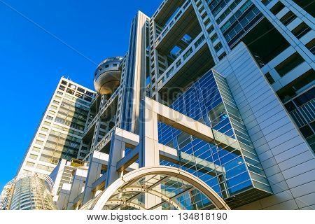 TOKYO JAPAN - NOVEMBER 27 2015: Fuji T.V. headquarters one of the most striking buildings in Japan. its' futuristic metallic clad building featuring a massive silver ball 32 metres in diameter