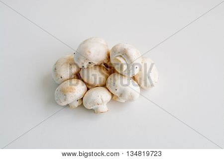 White champignon mushrooms and sliced mushrooms isolated on light background