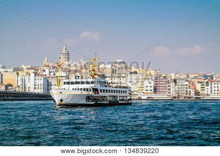 Istanbul ferry on Bosphorus Turkey. Passenger Ferry on Bosporus. Ship on Bosporus with Galata Tower on background. View from Istanbul with Galata Tower and the ferry.