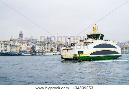 Istanbul ferry on Bosphorus Turkey. Passenger Ferry on Bosporus. Ship on Bosporus with Galata Tower on background. View from Istanbul with Galata Tower and the ferry.