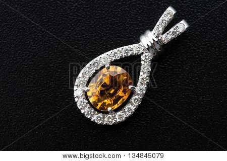 topaz and Silver diamond pendant on black background