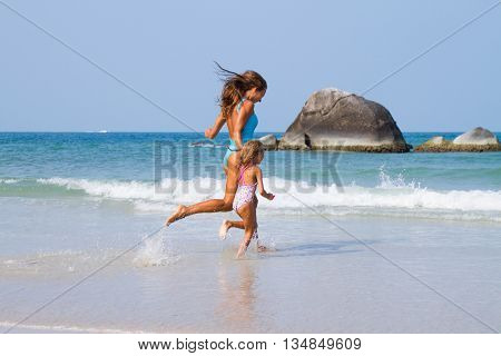 Mum with daughter on the beach in Thailand