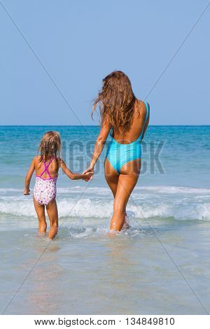 Mum with daughter on the beach in Thailand