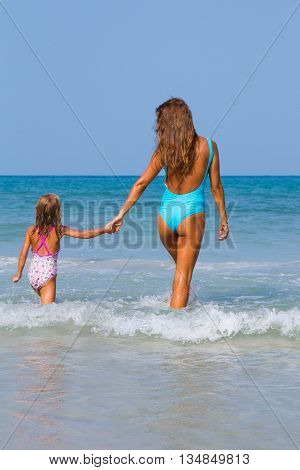 Mum with daughter on the beach in Thailand