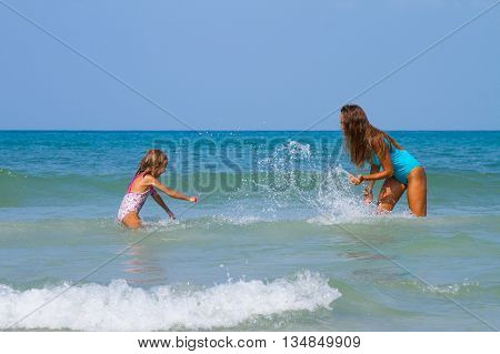 Mum with daughter on the beach in Thailand